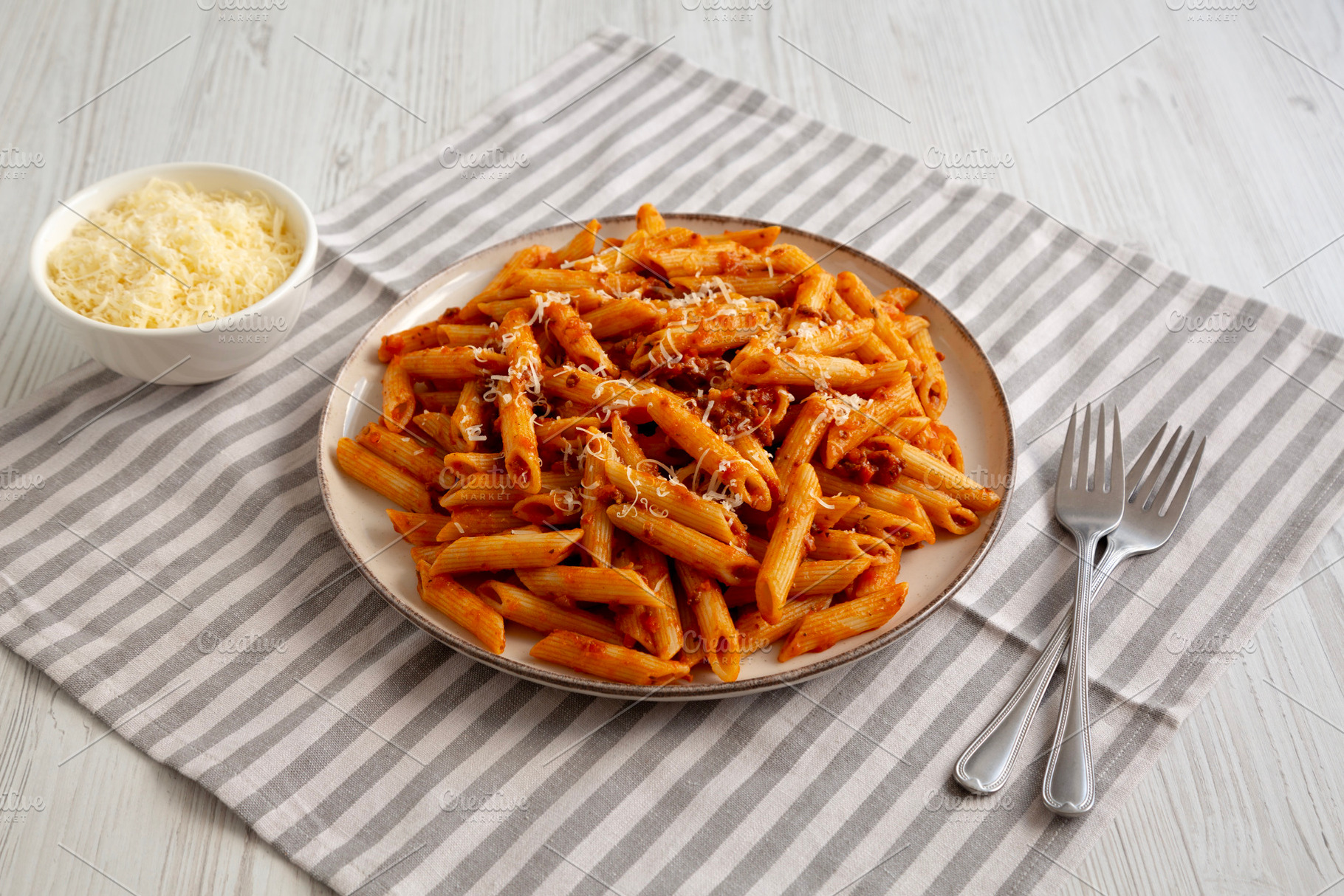 Homemade Pasta Bolognese with Cheese on a Plate, side view., a Food & Drink Photo by LiudmylaChuhunova