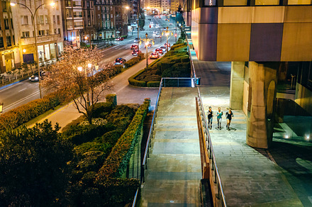 Women friends runners training together on the city at night