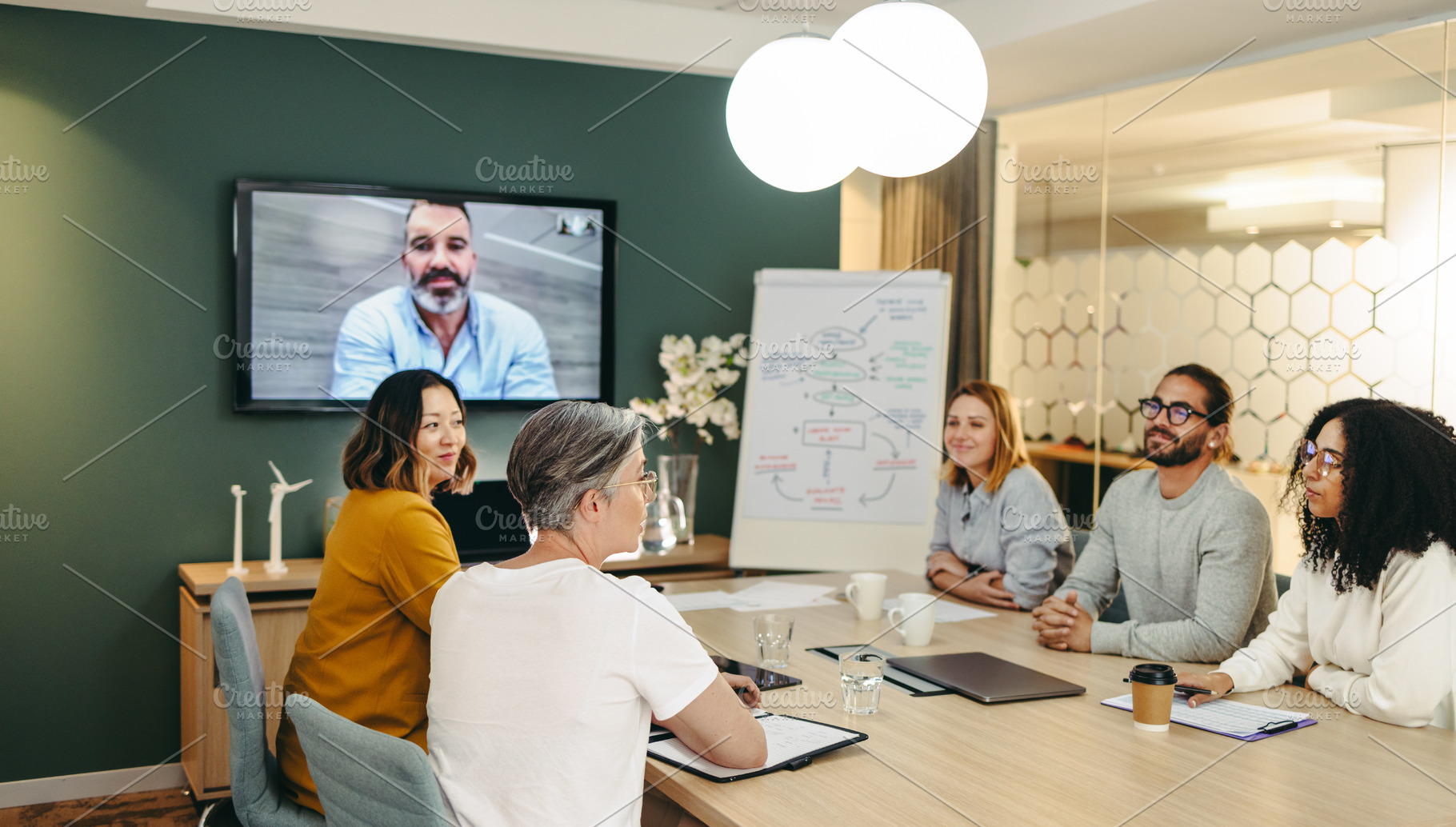 Diverse business professionals having a video conference in an office, a Person Photo by Jacob Lund