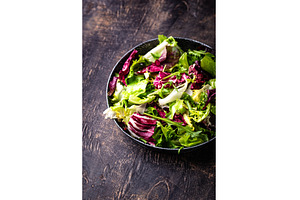 Bowl of fresh green salad mix, a Food & Drink Photo by Yulia Furman