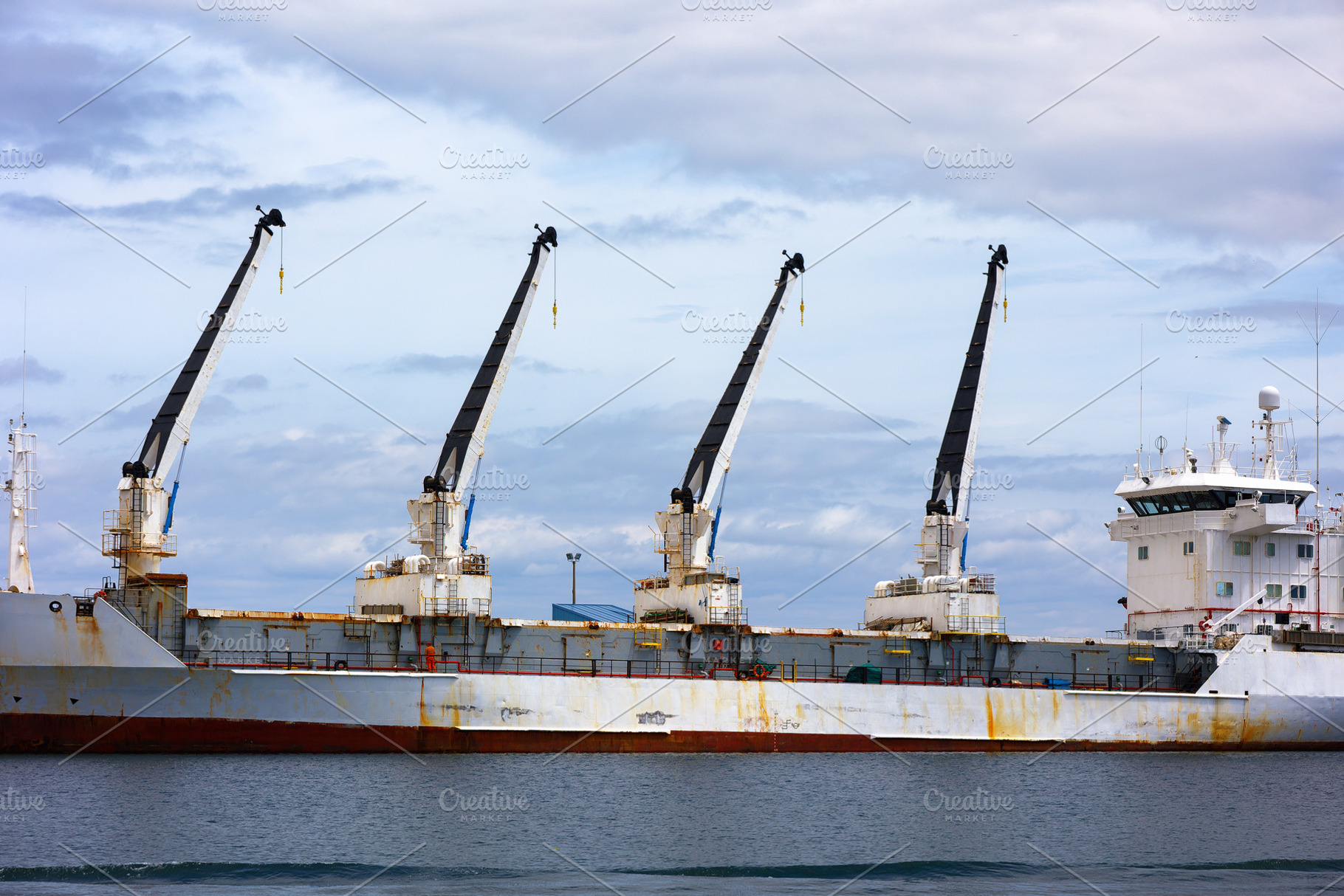 Industrial cargo ship with cranes in, an Industrial Photo by Perpis
