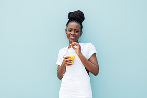 Smiling woman against blue wall, a Person Photo by Artem Varnitsin