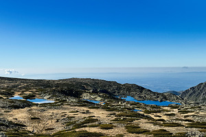 Scenic high-altitude terrain with ponds in Portugal, Serra da Estrela under cle, a Photo by AS photostudio