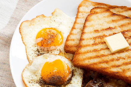 Homemade Healthy Sunnyside Eggs Breakfast on a white plate on a, a Food & Drink Photo by LiudmylaChuhunova