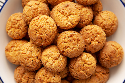 Homemade Sweet and Crunchy Amaretti on a Plate, top view. Flat l, a Food & Drink Photo by LiudmylaChuhunova