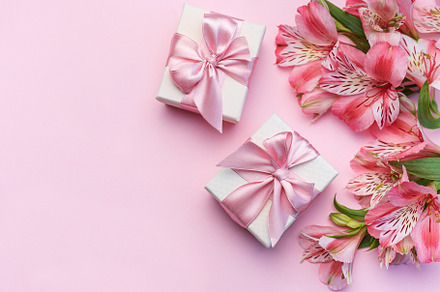 Beautiful Alstroemeria flowers and gift boxes on pink background, a Holiday Photo by Olena Rudo