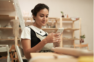 Woman using smartphone in pottery, a Person Photo by Sergey Mironov's store