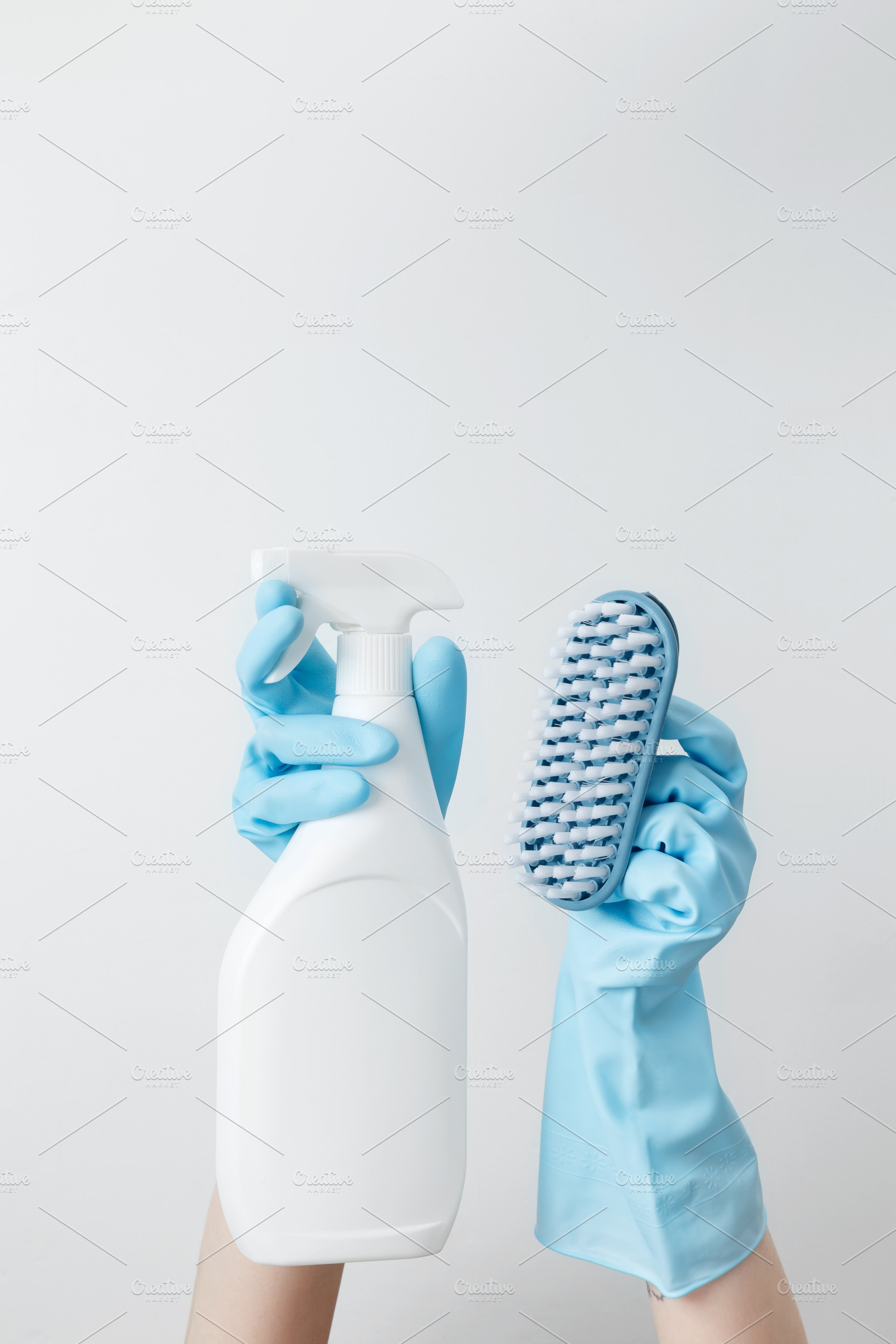 Woman in rubber gloves holding cleaning spray and brush, ready for household cl, a Photo by matucha