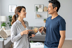 Interior decorators working together in a well lit home setting, a Person Photo by DanFLCreativo