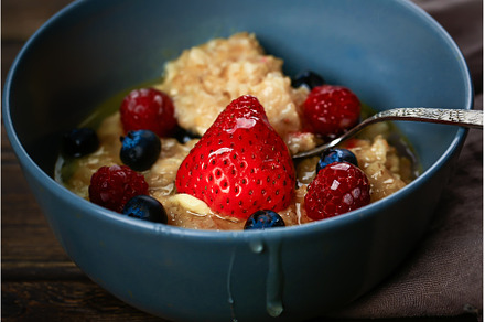 Oatmeal with berries on a wooden, a Food & Drink Photo by sabyna75