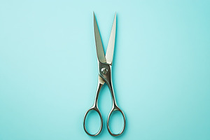 Sterile surgical scissors on blue background, a Photo by AlyaAnd