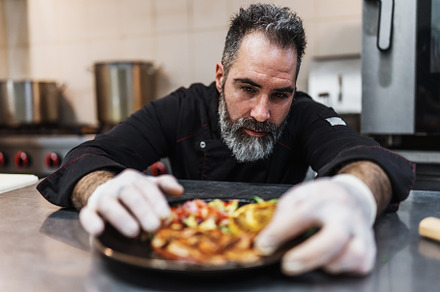 Professional chef preparing food, a Person Photo by REDDOT Studio