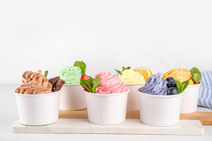Frozen yogurt assortment. Soft creamy ice cream cups, a Food & Drink Photo by Rimma