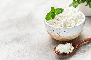 Cottage cheese in bowl with mint leaves, a Food & Drink Photo by Olena Rudo