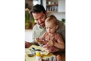Father and little son decorating, a Holiday Photo by HalfPoint