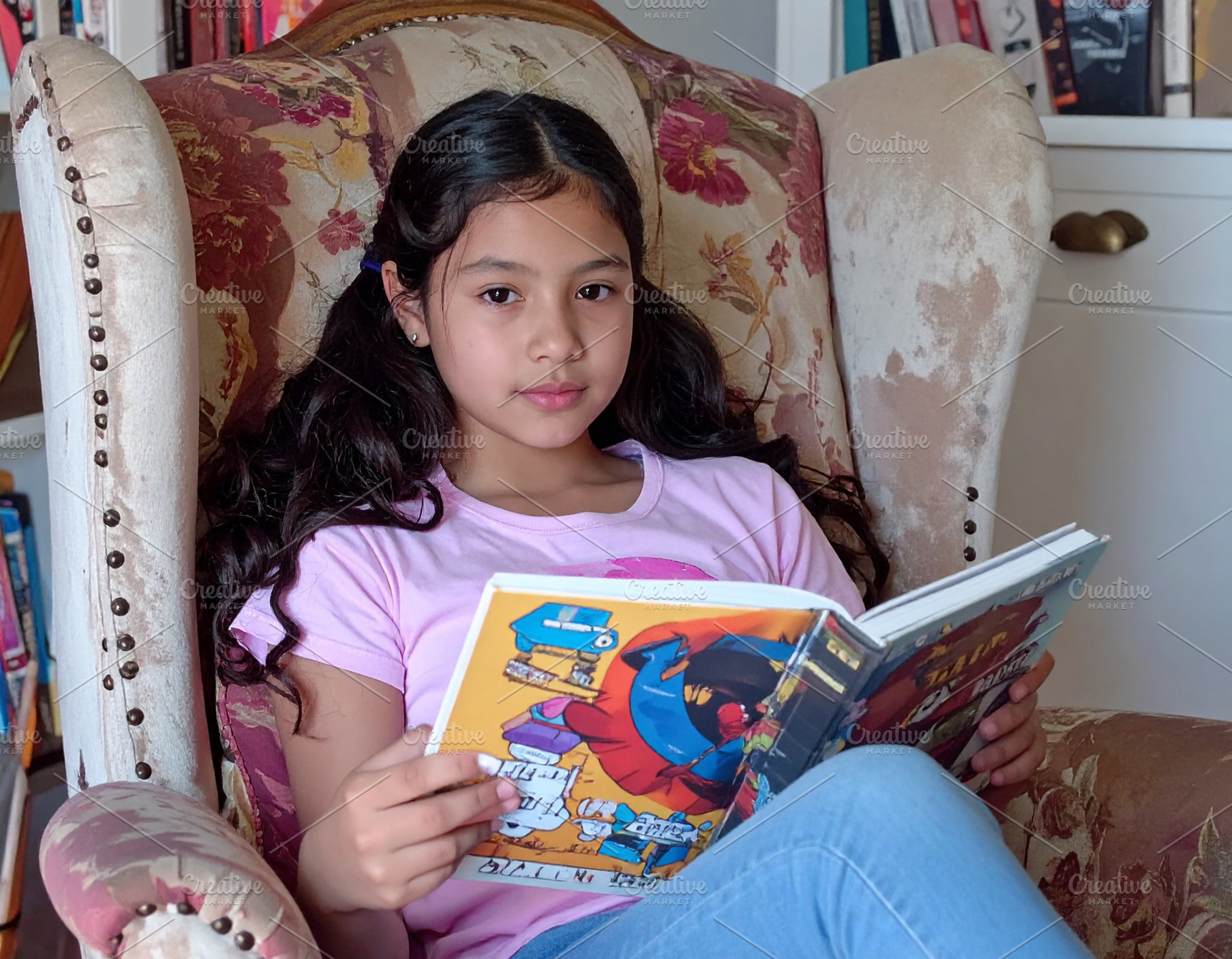 A girl reading comics at sofa, a Person Photo by DanFLCreativo