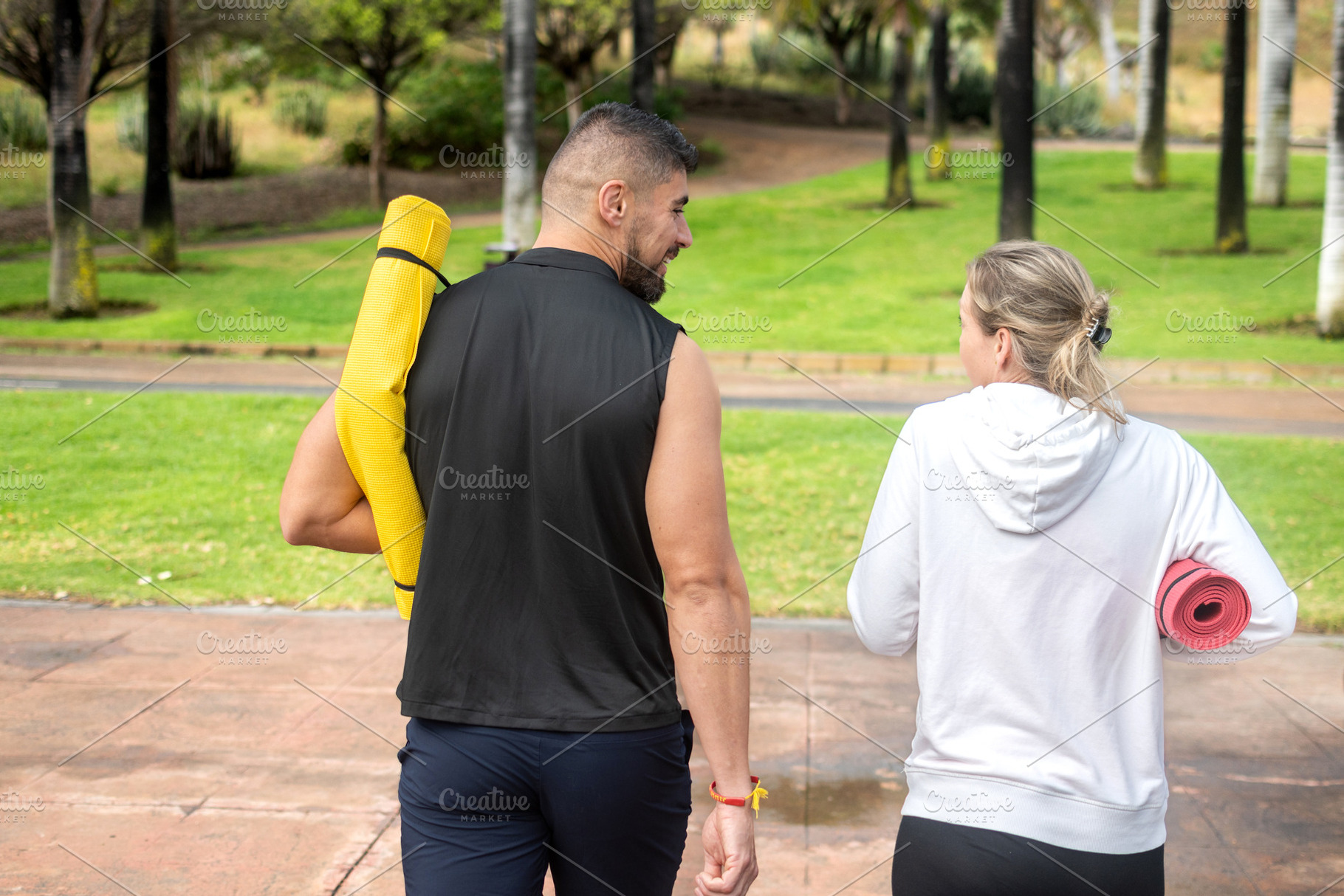 Friends walking with yoga mats in the park, a Sports & Recreation Photo by etorres69