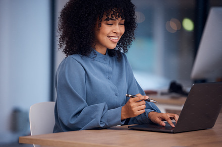 Happy, working and black woman typing on a laptop for email, connection and internet. Business, smile and employee reading from the web on a computer for work, project and freelancing in office, a Photo by Peopleimages.com