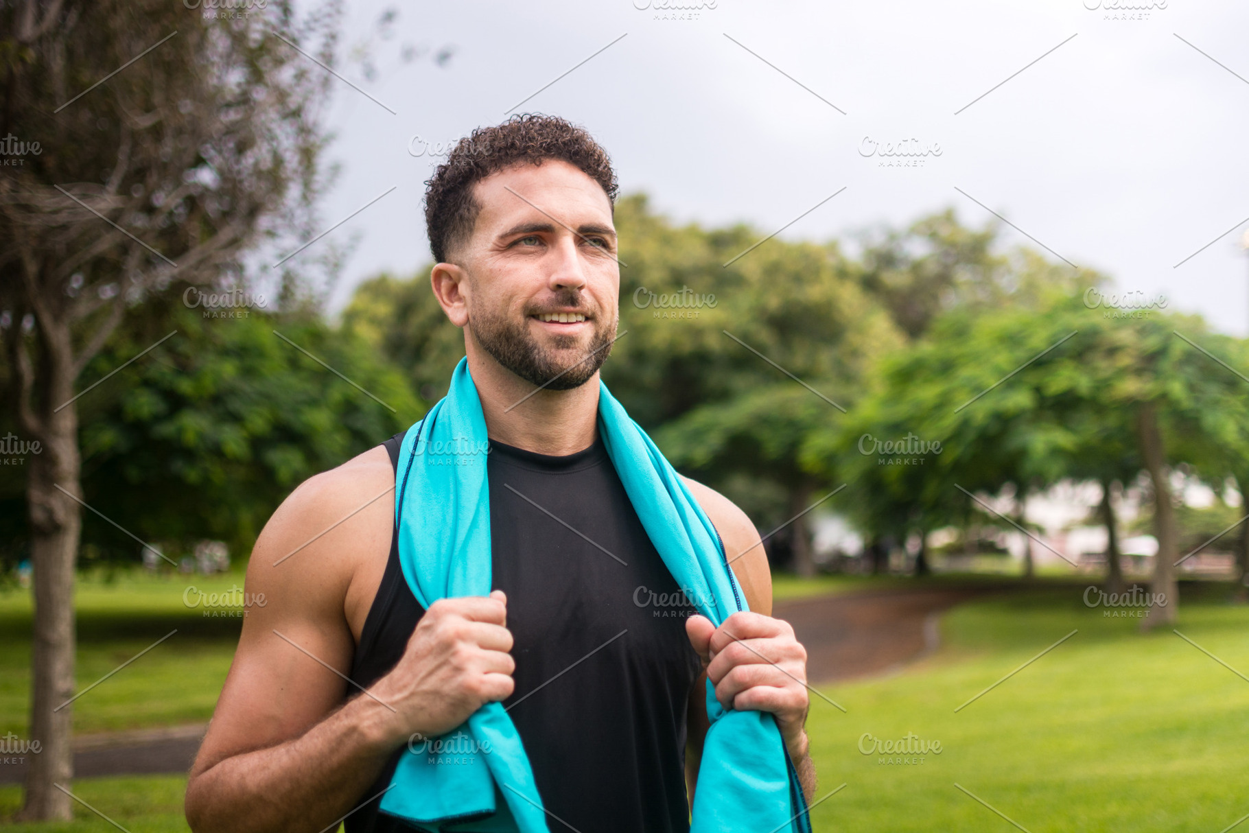 Smiling athletic man resting after fitness workout in green park, a Photo by etorres69