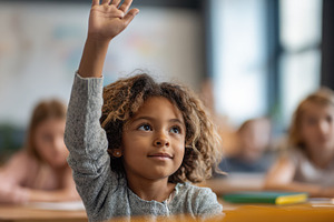 Child raising hand in classroom, a Photo by Beautiful things