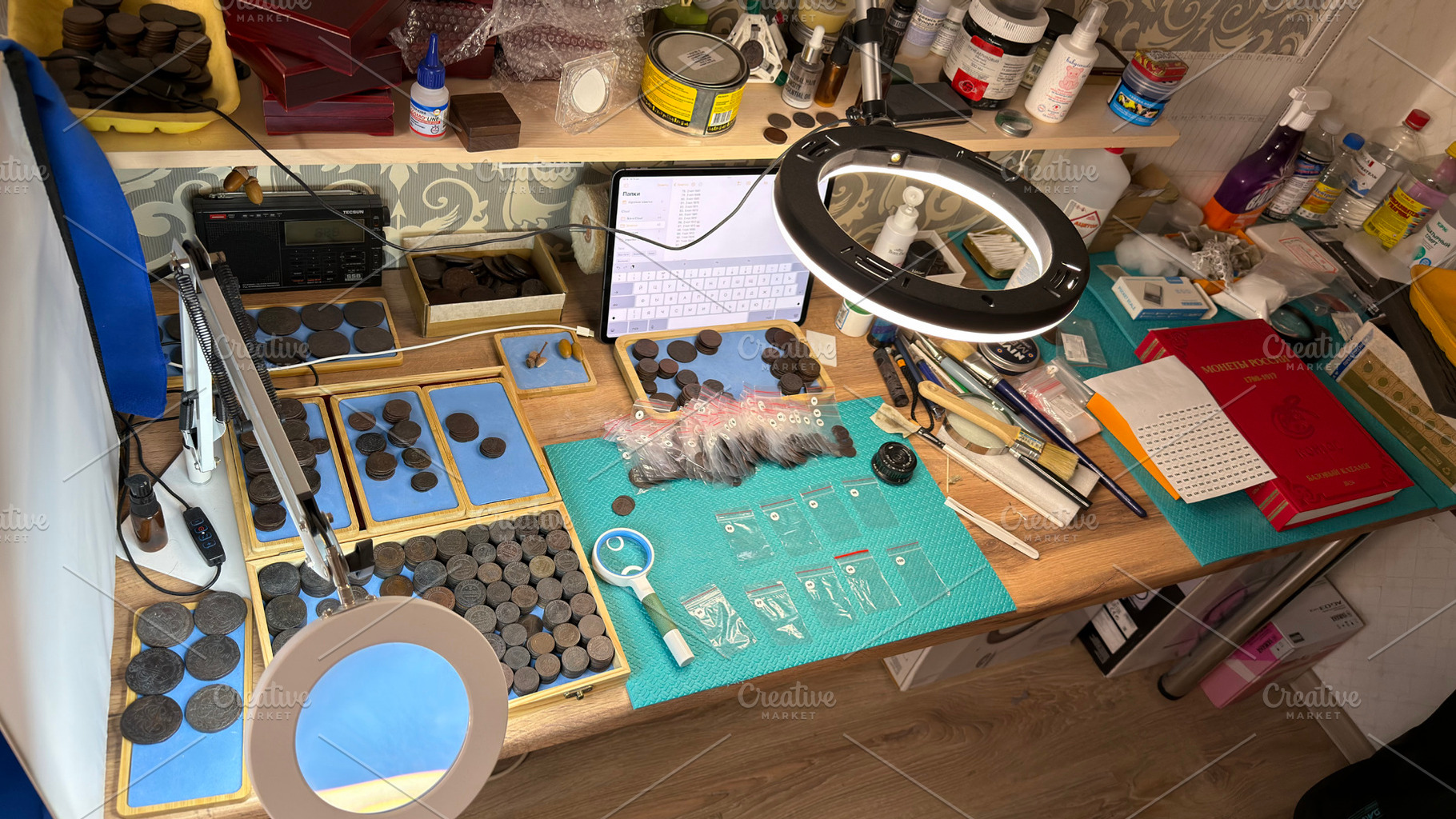 A cluttered workspace with coins, magnifying glass, and tools for coin examinat, an Industrial Photo by Textures & Backgrounds