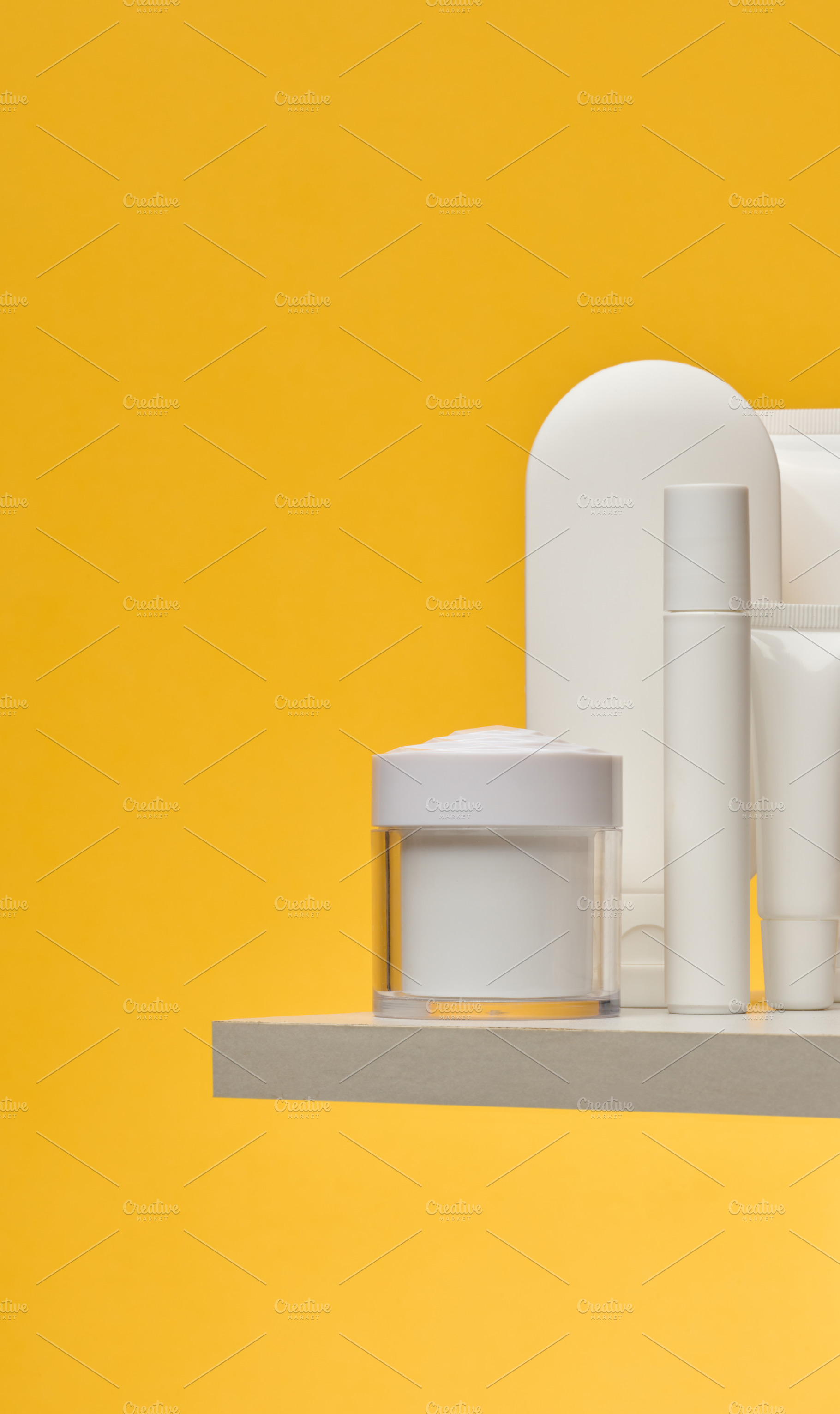Set of white cosmetic packaging without brand on yellow backgrou, a Beauty & Fashion Photo by ndanko