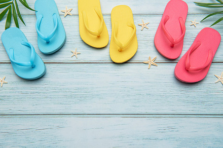 Colorful flip flops and starfish creating summer vacation atmosp