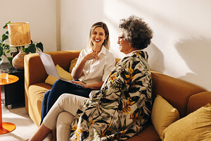 Happy entrepreneurs working together on a couch, a Person Photo by Jacob Lund