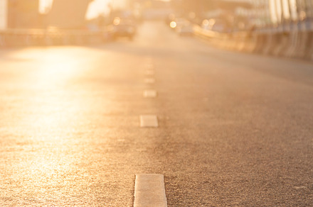 Road with sun lighting featuring symbol, surface, and street, a Transportation Photo by a454
