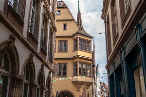 Narrow street with historic buildings in Strasbourg, France, an Architecture Photo by GoodGoods