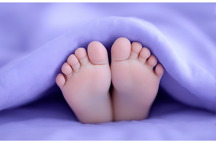 A baby girl's feet are wrapped in a, a Person Photo by ZinetroN