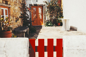Red gate and white stucco wall, an Architecture Photo by SkyNext