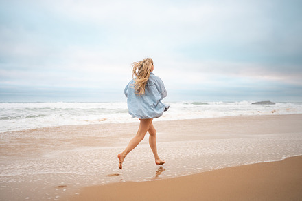 Woman running on sandy sea beach during summer vacation, a Person Photo by andreonegin market