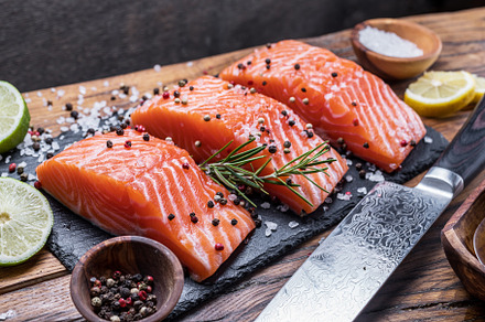 Fresh salmon fillets on black cuttin stock photo containing basil and black, a Food & Drink Photo by Volff