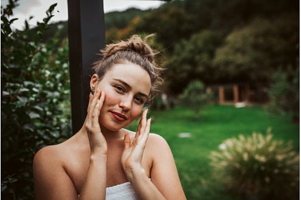Beautiful woman touching her face, a Beauty & Fashion Photo by HalfPoint