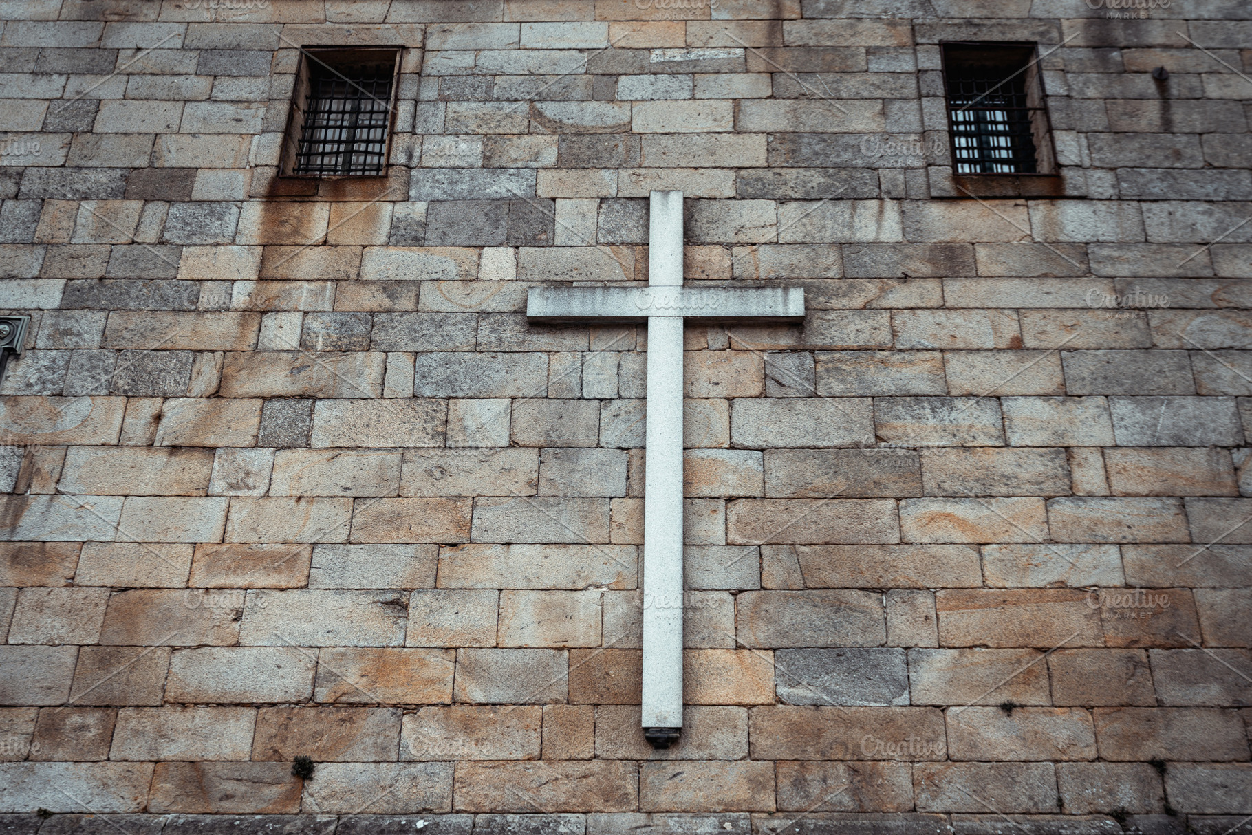 Stone wall with white cross detail, an Architecture Photo by SkyNext