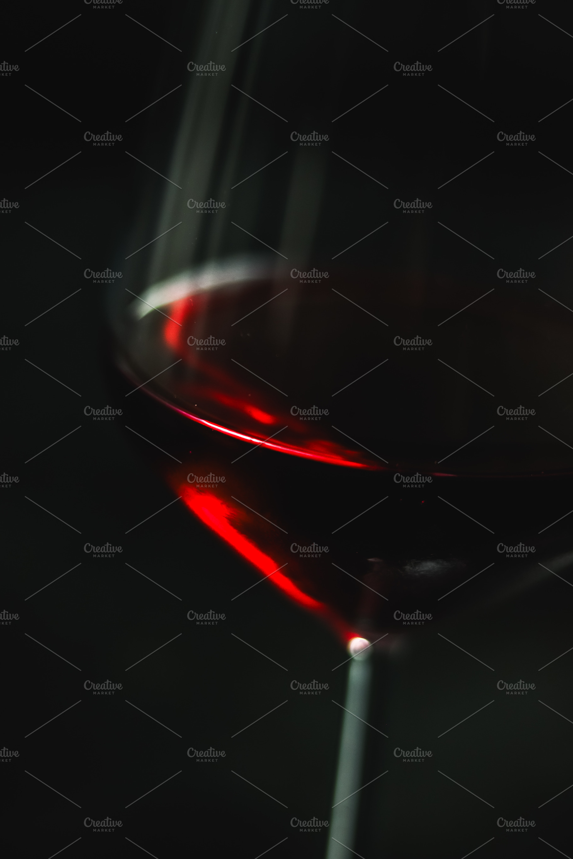 Red wine swirling inside an elegant wine glass against a dark background, showi, a Photo by Studio ANNA