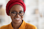 Closeup portrait of pretty young black lady wearing red headscarf, a Photo by Prostock-Studio (Thumbnail 2 of 2)