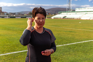 Woman inserting wireless earbud, a Photo by Grafvision photography