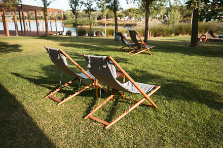 Wooden lounge chairs on lawn, a Sports & Recreation Photo by SkyNext