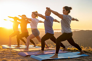Diverse group practicing yoga at nature, a Health & Medical Photo by DanFLCreativo