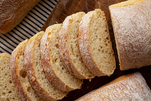 Homemade Ciabatta Bread on a wooden board, top view. Close-up., a Food & Drink Photo by LiudmylaChuhunova