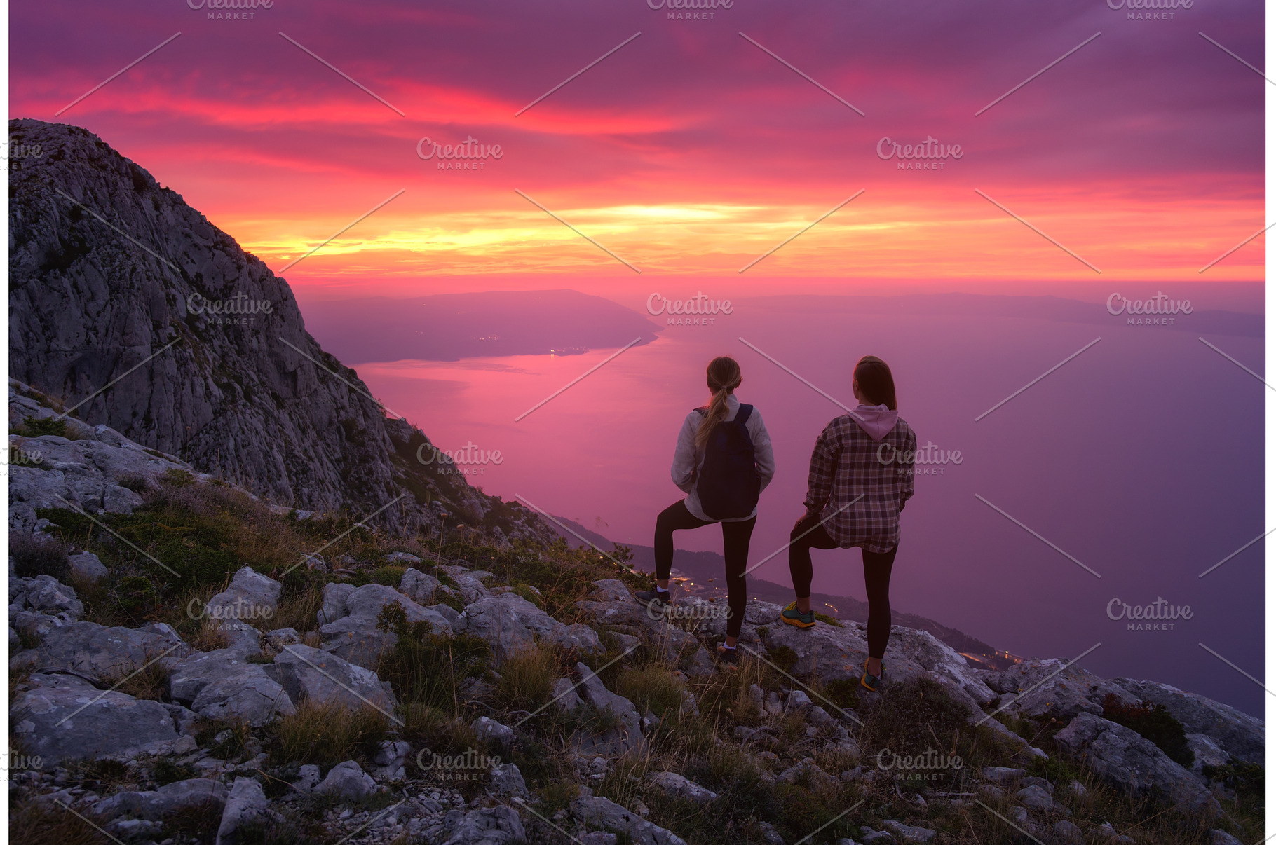 Two women hikers with backpacks, a Nature Photo by den-belitsky