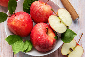 Fresh red apples with water drops and green leaves, a Food & Drink Photo by Olena Rudo