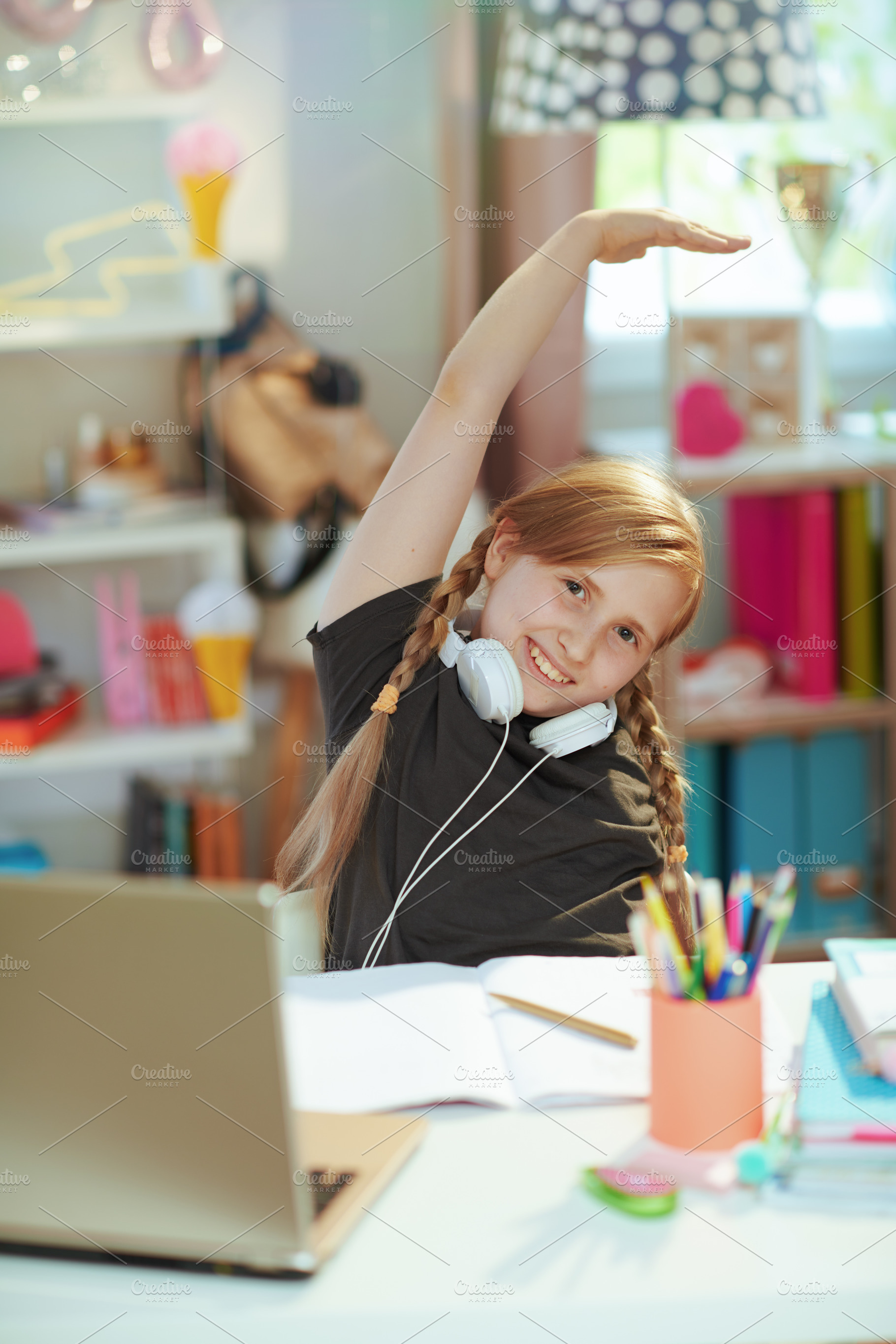 tired pupil learning online and stretching at home in sunny day, a School & Education Photo by Alliance Images
