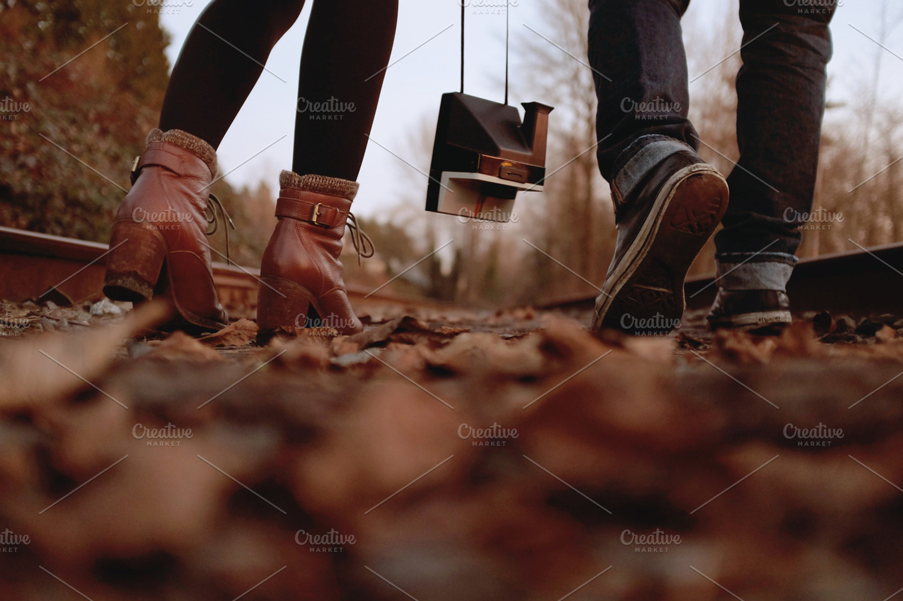 Couple walking on railway tracks