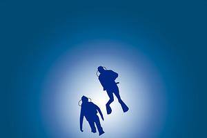 Divers in the blue sea.