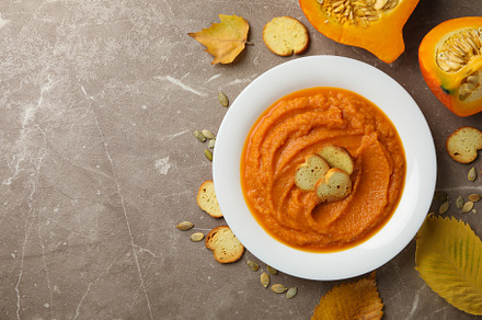 Composition with plate of pumpkin puree with croutons on gray ba, a Food & Drink Photo by AtlasStudio PRO