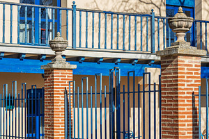 Building facade with blue railings a, an Architecture Photo by Perpis
