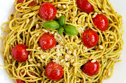 Homemade Pesto Pasta with Tomatoes and Pine Nuts on a black back, a Food & Drink Photo by LiudmylaChuhunova